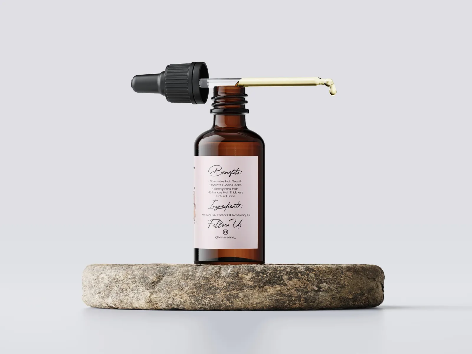 ReviveLine Growth Oil dropper releasing a drop of Minoxidil 5% hair regrowth oil
